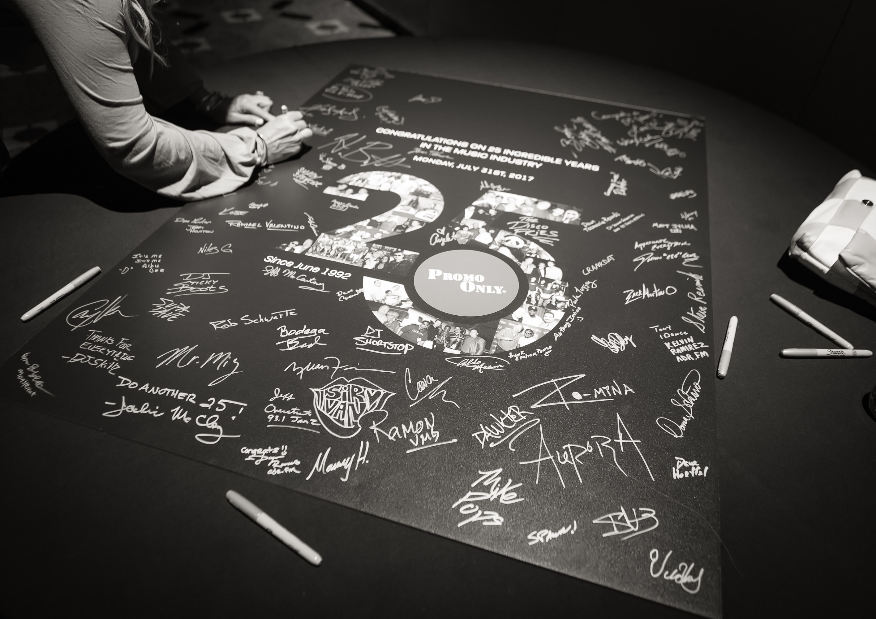 A person signs a poster
